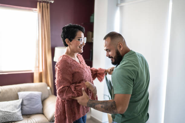 istock Mid adult couple dancing at home 1397738433