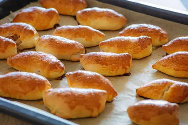 freshly baked meat buns on baking pan, selective focus