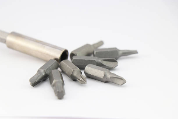 istock Drill bits of various shapes along with screwdriver head on white background 1397741569
