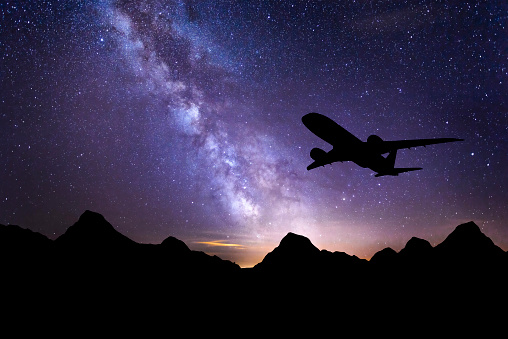 Travel background. Passenger airliner. Commercial airplane. Business .Night time long exposure landscape photography. composite image