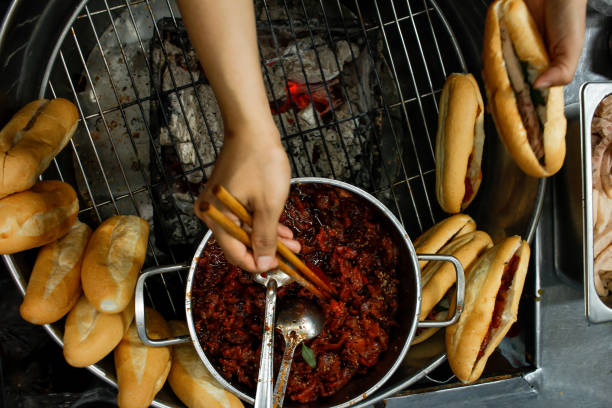 istock Directly above view of hands stuffing pork into banhmi 1397745133