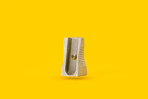 Photo of Metal sharpener floating on a yellow background