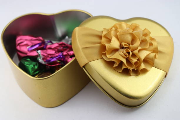 Heart shape gift box with chocolates inside on white background, Gift boxes for birthdays, valentines day and other special events