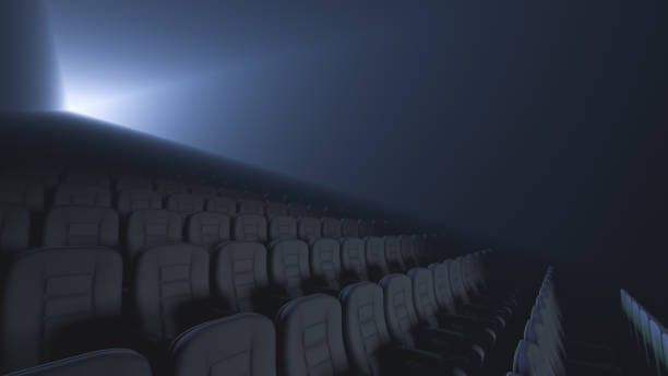 istock Empty seats in the auditorium. Movie projector beams in the background 1397745496