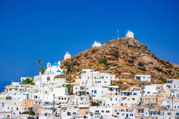 Traditional houses, wind mills and churches in Ios island, Cyclades, Greece.