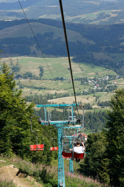 istock Ski elevator with red chairs moving down. Carpathians Gimba Mountain. 1397747034