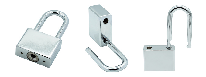 A metallic padlock without key. Silver padlock locked