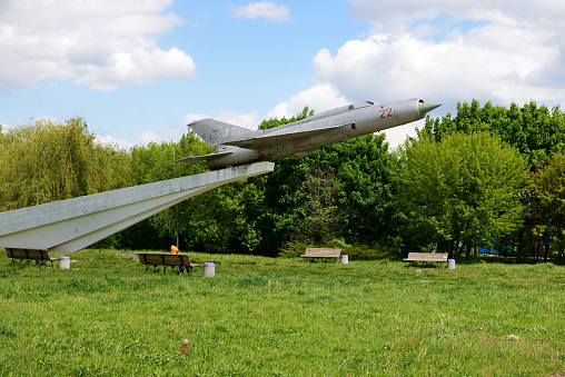 Bila Tserkva, Ukraine -  May 15, 2022: The view on MIG-21 supersonic jet fighter and interceptor aircraft memorial dedicated to Soviet pilots who release of Bila Tserkva town from German invadors in Second World War. According to towns authority it will be dismount soon.