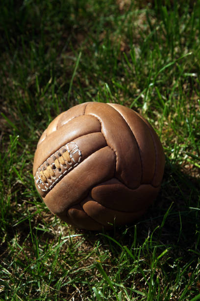 istock Retro soccer ball on grass 1397749235