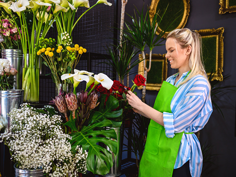 Young florist working in her shop