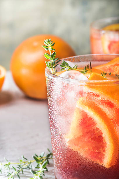 istock Red cocktail with Campari or bitter with  Sicilian red oranges (tarocco) on light gray concrete background, copy space. Aperitif with Americano cocktail. Natural eco  aesthetic, mint green background, front view 1397753658