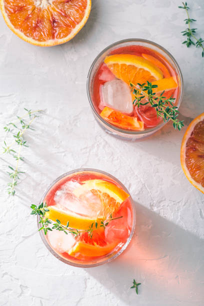 istock Red cocktail with Campari or bitter, Spritz  with  Sicilian red oranges (tarocco) on light gray concrete background, copy space. Aperitif, natural eco aesthetic, white background, top view 1397753675
