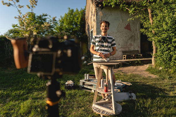 istock Caucasian male craftperson with camera, recording DIY tutorial 1397753999