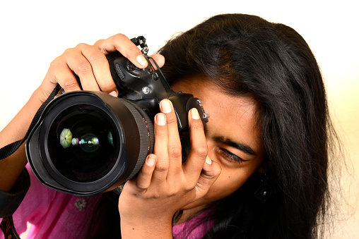 A female photographer shooting with a DSLR