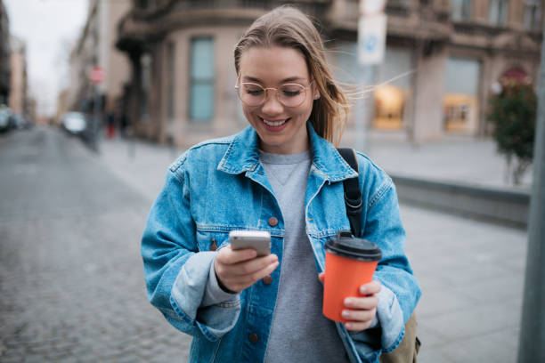 istock Happy young woman using a smart phone 1397756709