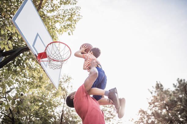 father and son playing basketball - basketball basketball player shoe sports clothing imagens e fotografias de stock