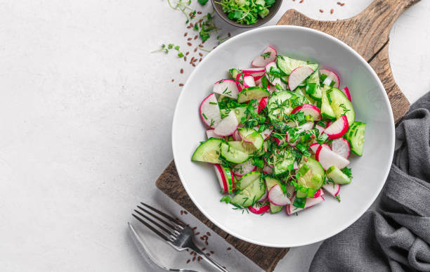 istock Salad with radish, cucumber, micro greens and flax seeds on a light background. 1397757246