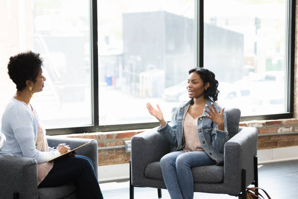 istock Young woman talking to her therapist 1397757285
