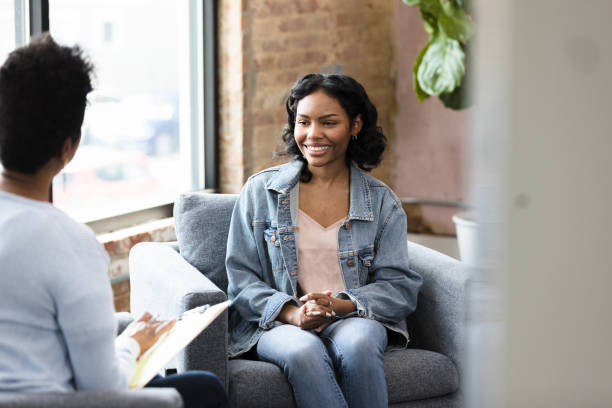 istock Young woman smiling at her therapist 1397757288