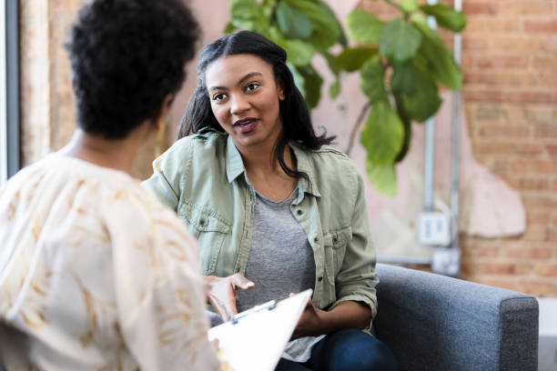 istock Young adult meets with her therapist 1397757302