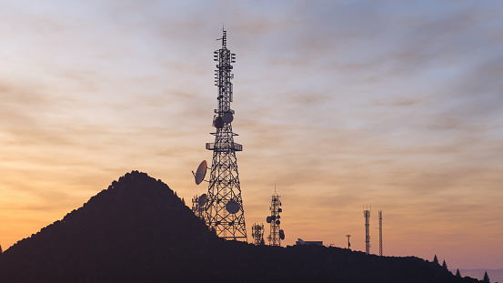 Telecommunication tower with antennas for 5g network on the mountain.