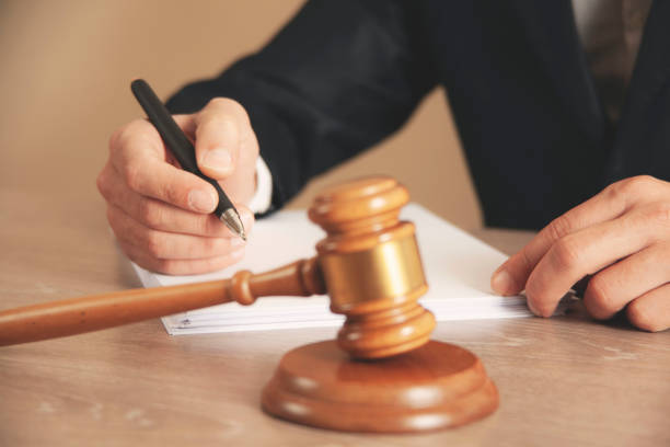 istock man hand wooden judge with document 1397760873