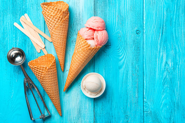 istock Berry ice cream, waffle cups and a spoon on a blue background. 1397761280
