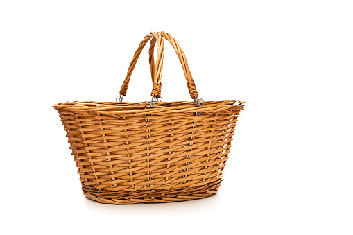 Front view of an empty picnic wicker basket with two handles isolated on white background. High resolution 42Mp studio digital capture taken with SONY A7rII and Zeiss Batis 40mm F2.0 CF lens