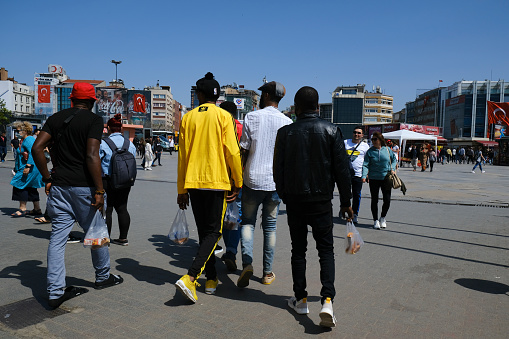 Istanbul, Turkey - April 24, 2022: African tourists or maybe immigrants in Istanbul Kadikoy in a sunny day.