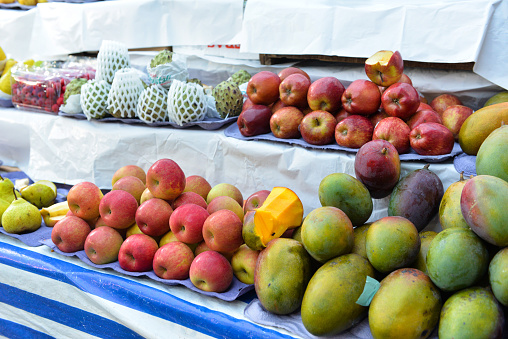Tropical fresh fruits stacked high at a local market in Belize