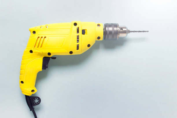 istock Home renovation yellow drill on blue background. Image with copy blank space 1397763299