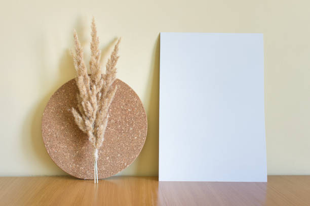 istock Mockup template with blank white A4 paper card with decorative cork circle and dry fluffy plants 1397763908
