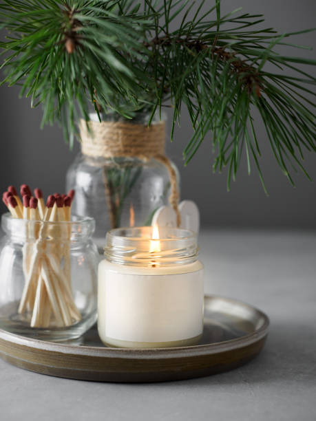 istock Burning candles and green branches on grey table, space for text 1397766867