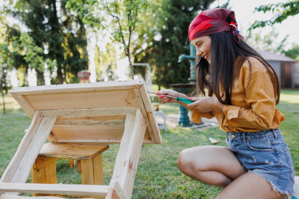 istock Handyman is assembling flat pack furniture with help of screwdriver 1397770340