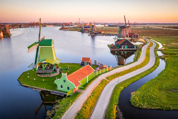 Windmills at Zaanse Schans in Holland at sunrise. Zaandam, Netherlands Netherlands rural lanscape - aerial view of windmills at famous tourist site Zaanse Schans in Holland. Zaandam, Netherlands early in the morning zaanse schans stock pictures, royalty-free photos & images