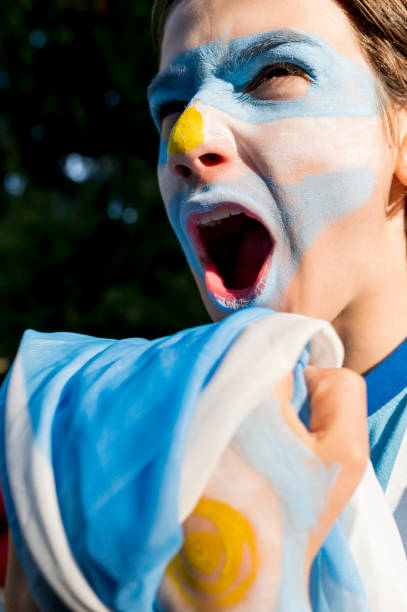 Argentina fan cheering loudly during the match. stock photo