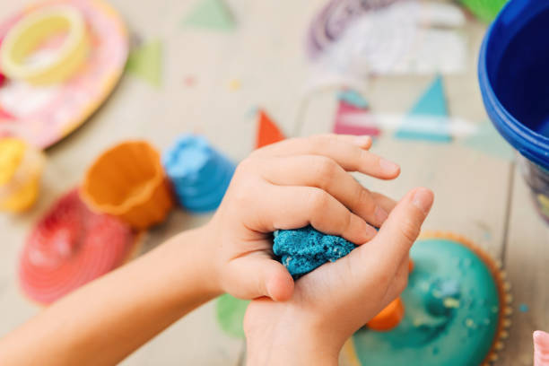 istock kinetic sand. children's hands play with multi-colored polymer sand. 1397775982