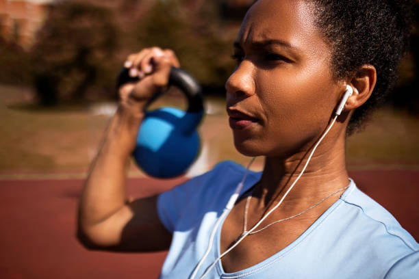 istock Serious African American Woman Exercising with weights 1397776248