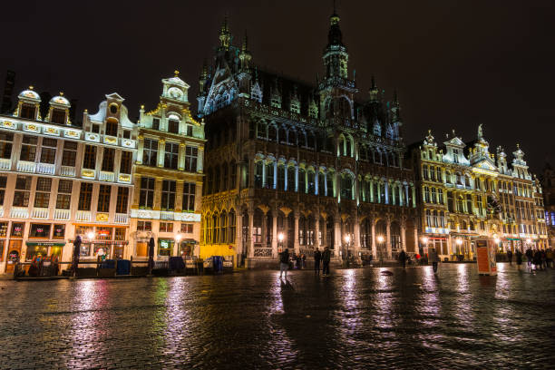 Maison Du Roi in the Grand Place illuminated at night.