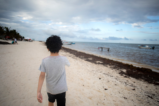 child walking on the beach, Puerto Morelos