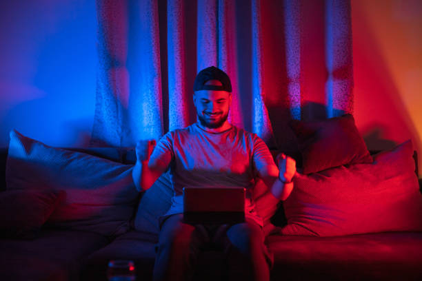istock Cheerfull young man playing online game on digital tablet 1397779219