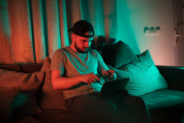 istock Young man sitting in a cosy couch using digital tablet 1397779267