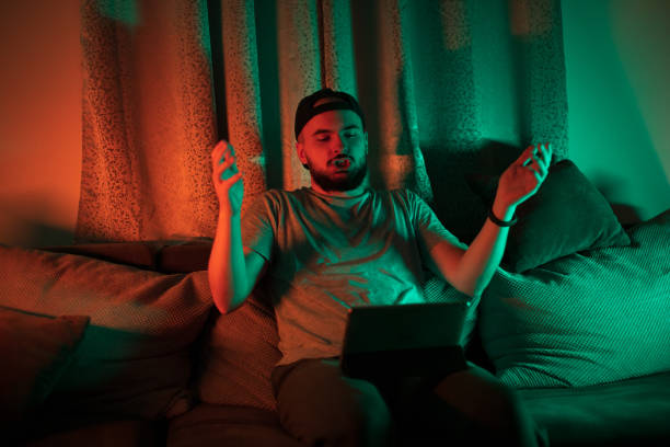 istock Young man playing online game on digital tablet 1397780417