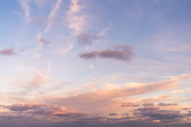 istock Beautiful sky replacement background with pink, yellow and orange colored clouds on a blue sky backdrop. 1397781334