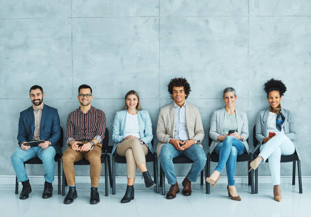 mężczyzna krzesło biznesowe siedzący czekająca kobieta biznesmen kandydat rekrutacja businesswoman biuro biznesmen praca młoda linia rozmowy kwalifikacyjnej - unemployment waiting in line waiting room interview zdjęcia i obrazy z banku zdjęć