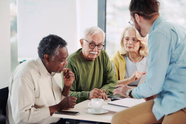 istock A young educator in classroom showing to senior students lesson on tablet. 1397783985