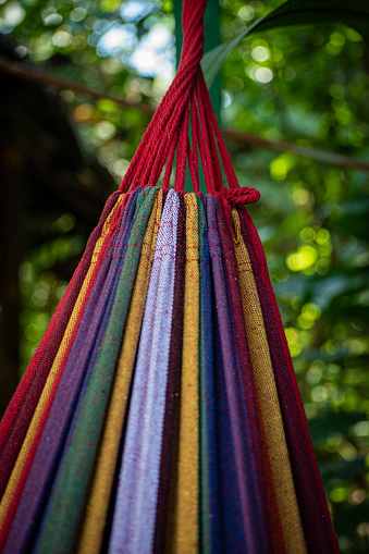 Bright multicoloured fabric at the end of a hammock.