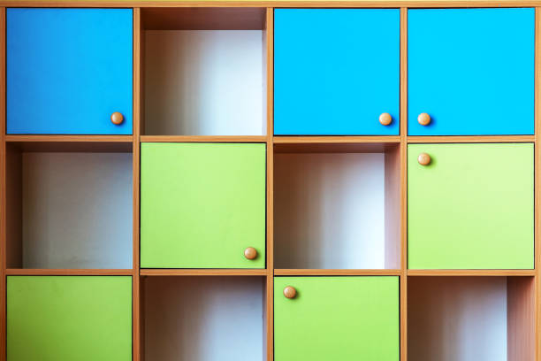 Multi colored wooden cabinet compartmentalize on cells with empty shelves front view