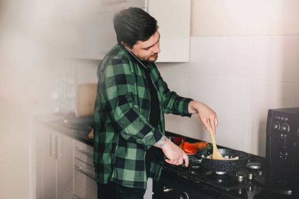 istock Young man cooking dinner at the kitchen. 1397785545