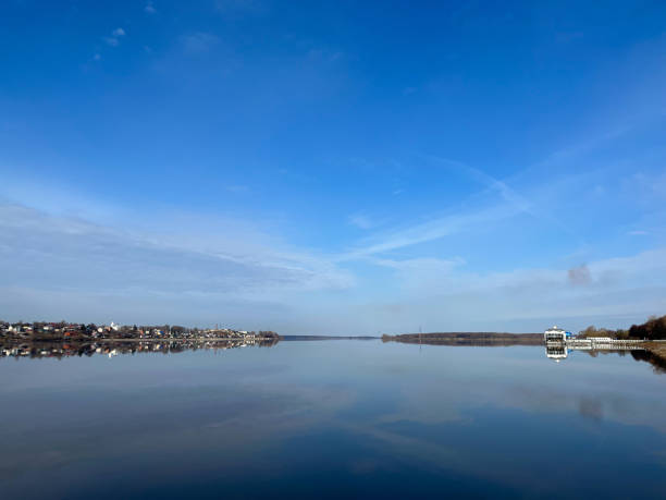 istock Peaceful sky reflection on the river surface, tender blue sky and bright water. Bridge on the horizon 1397786668